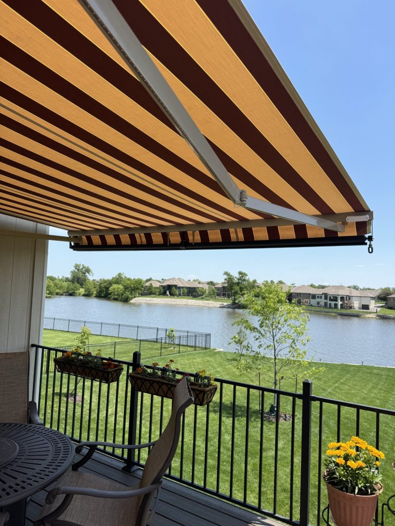 retractable awning over patio brown stripes